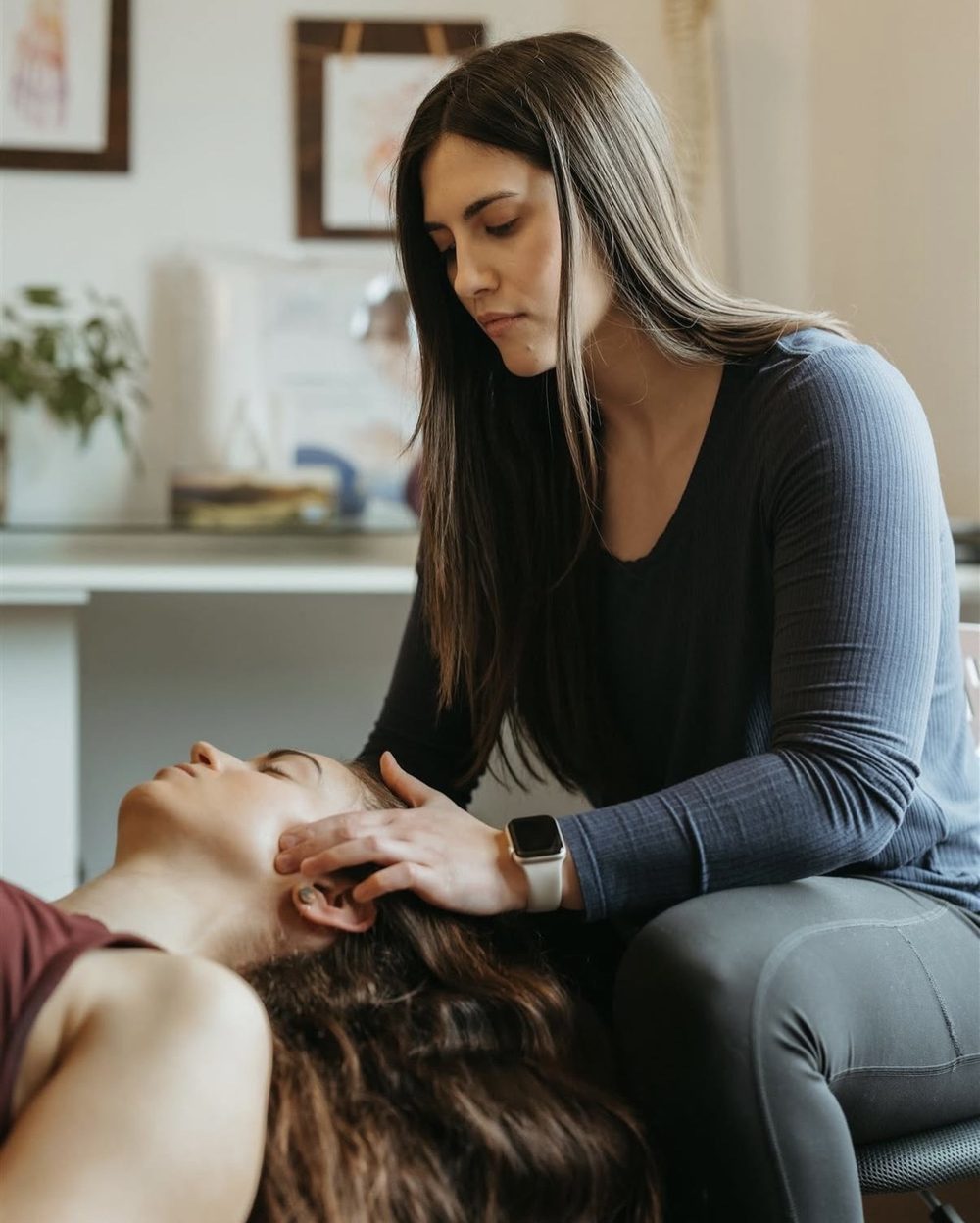 Dr. Maia Pidperyhora treating a patient's neck and jaw