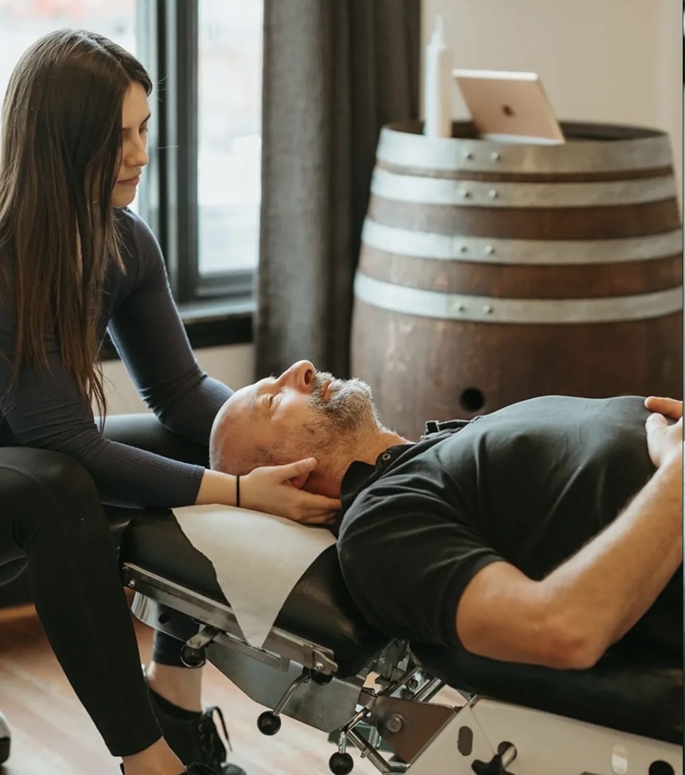 Dr. Maia working on the muscles of a patient's neck