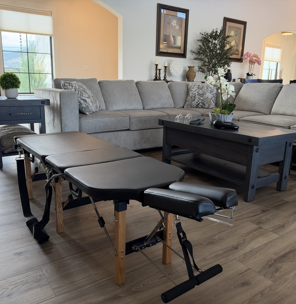 Dr. Maia's portable treatment table set up in a living room