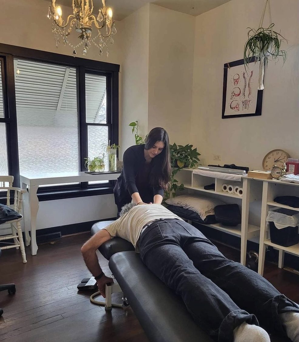Dr. Maia Pidperyhora treating a patient lying on the table